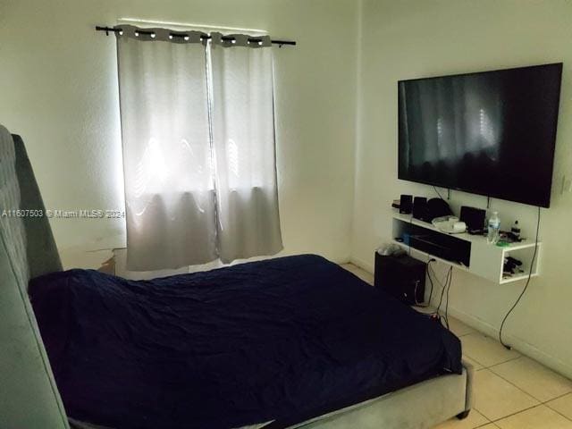 bedroom featuring light tile patterned floors