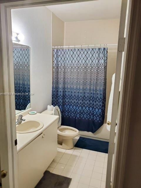 bathroom featuring a shower with curtain, tile patterned flooring, vanity, and toilet