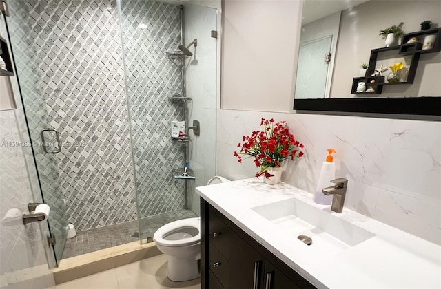 bathroom with a shower with shower door, tile flooring, oversized vanity, and toilet