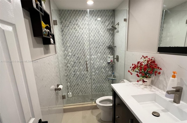 bathroom with vanity with extensive cabinet space, an enclosed shower, tile flooring, and toilet