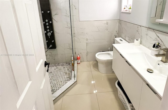 bathroom featuring tiled shower, tile floors, tile walls, vanity, and toilet