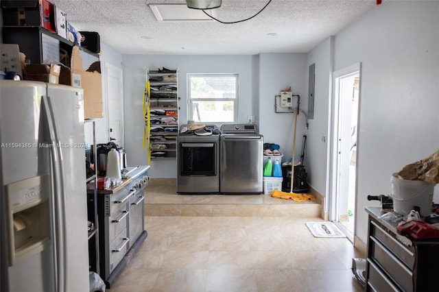 kitchen featuring a textured ceiling, stainless steel refrigerator with ice dispenser, independent washer and dryer, and light tile floors