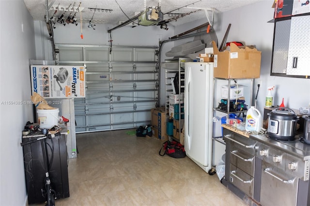 garage with white refrigerator and a garage door opener