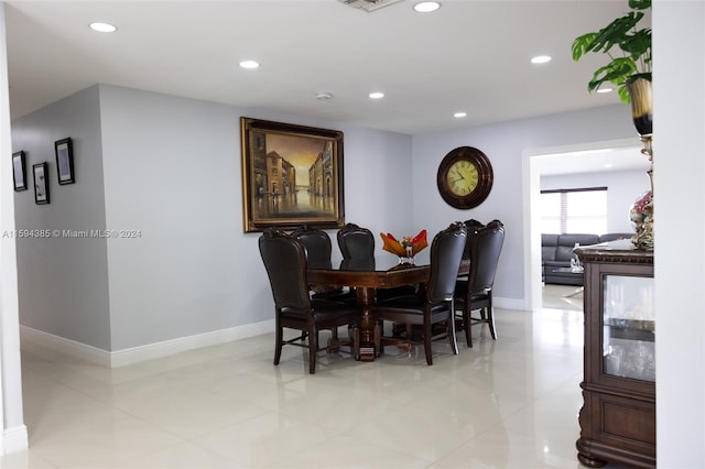 dining space featuring light tile flooring
