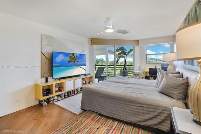 bedroom featuring ceiling fan, access to exterior, and hardwood / wood-style floors