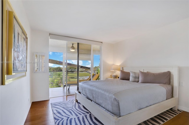 bedroom featuring access to exterior and hardwood / wood-style flooring