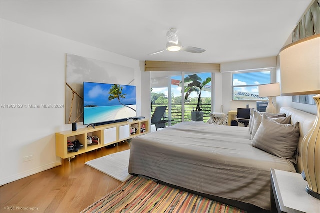 bedroom featuring wood-type flooring, access to outside, and ceiling fan