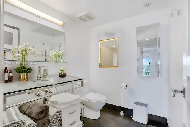 bathroom featuring vanity, toilet, and tile patterned floors