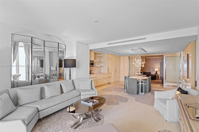 living room featuring a notable chandelier and light colored carpet