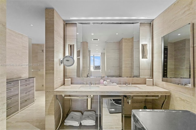 bathroom featuring vanity and tile walls