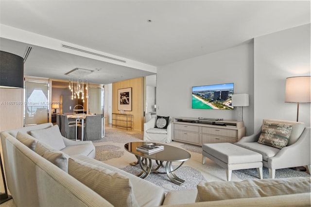 living room featuring light colored carpet and an inviting chandelier