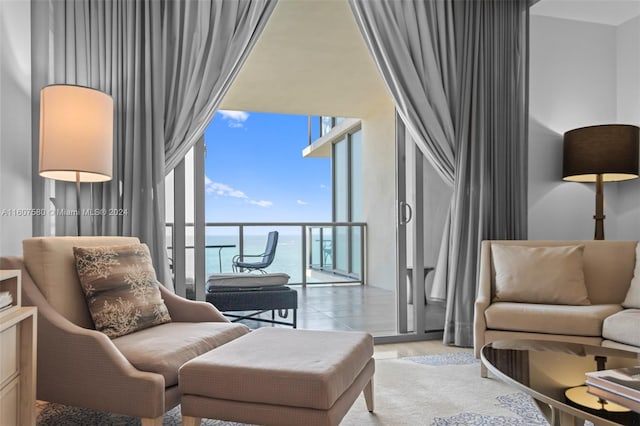 9703 Collins Ave Unit 1205, Bal Harbour, FL 33154 - living area featuring a towering ceiling, expansive windows, and a water view