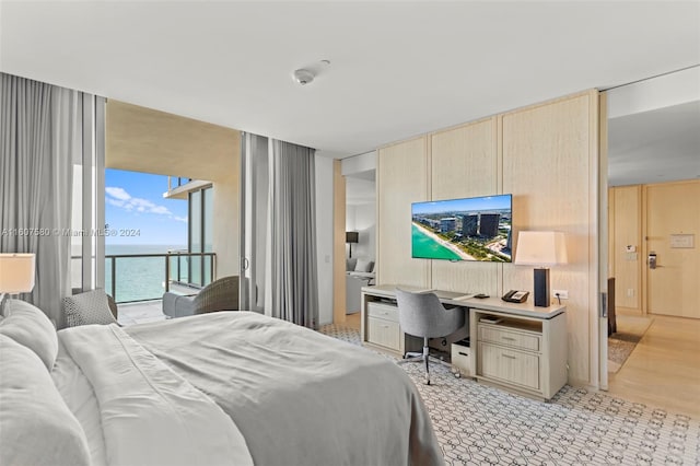 bedroom with light hardwood / wood-style flooring and built in desk