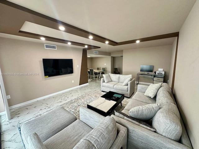 living room featuring a raised ceiling