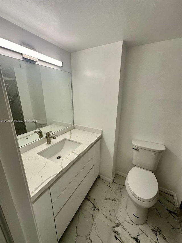 bathroom featuring vanity and toilet