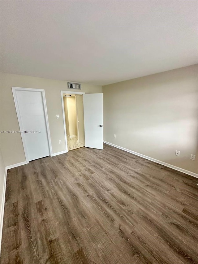 spare room with hardwood / wood-style floors