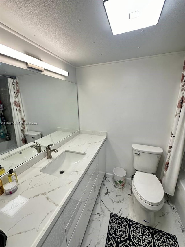 bathroom with vanity, a textured ceiling, and toilet