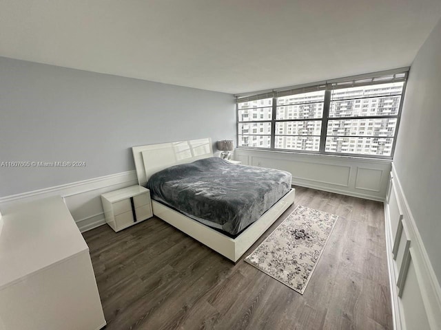 bedroom with dark hardwood / wood-style floors