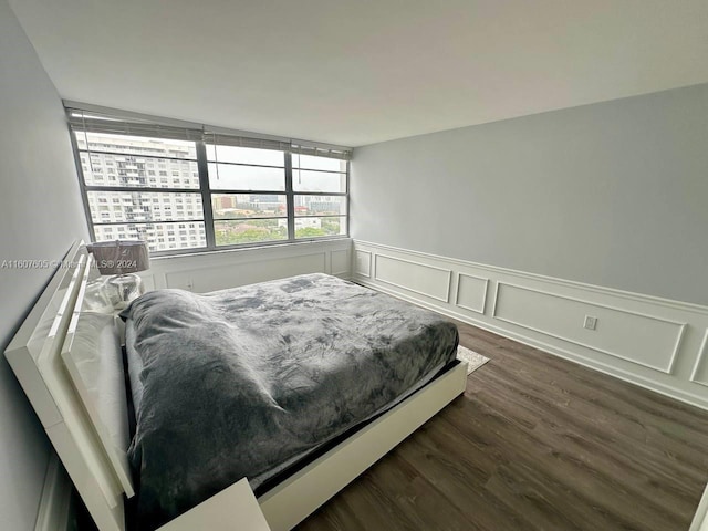 bedroom with dark hardwood / wood-style flooring