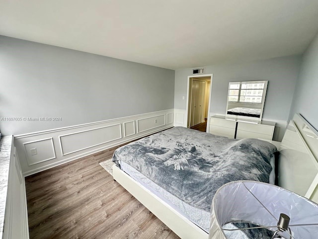 bedroom with hardwood / wood-style floors