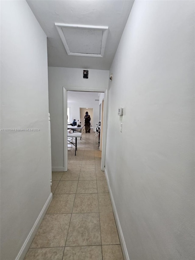 corridor with light tile patterned flooring