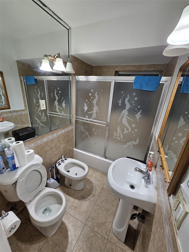 bathroom featuring tile patterned floors, a bidet, tile walls, and toilet