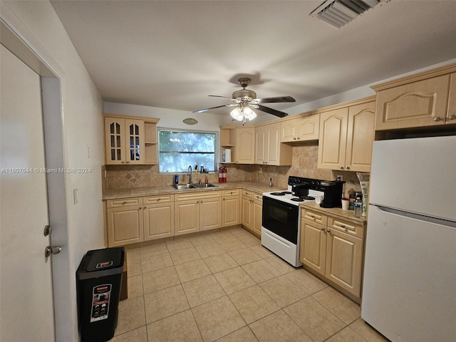 kitchen featuring white appliances, sink, light brown cabinets, backsplash, and light tile patterned floors