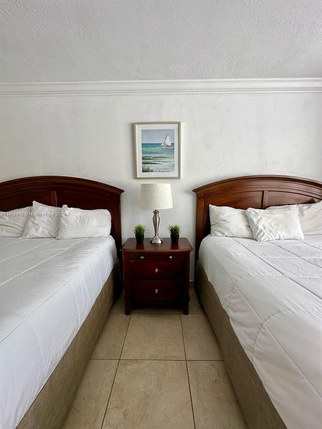 tiled bedroom with a textured ceiling