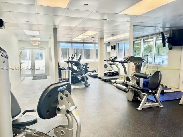 gym featuring french doors and a drop ceiling