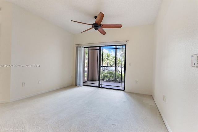 carpeted empty room with ceiling fan and a textured ceiling