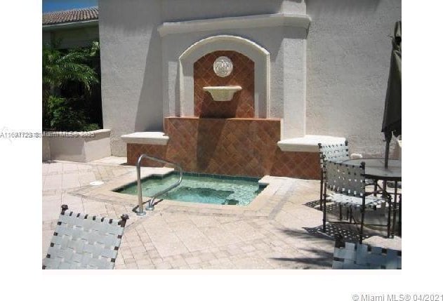 view of swimming pool with an in ground hot tub and a patio