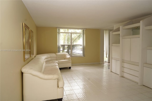 unfurnished living room featuring light tile floors