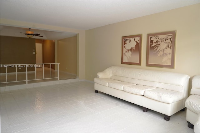 tiled living room with ceiling fan