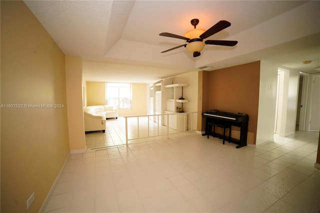 unfurnished living room with tile flooring and ceiling fan