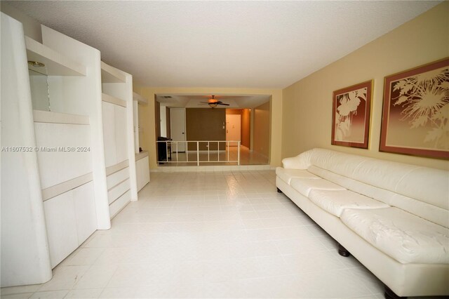 living room featuring ceiling fan and light tile floors