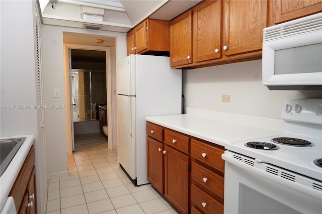 kitchen featuring white appliances and light tile floors