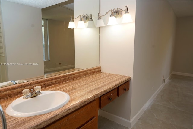 bathroom with tile floors and vanity with extensive cabinet space