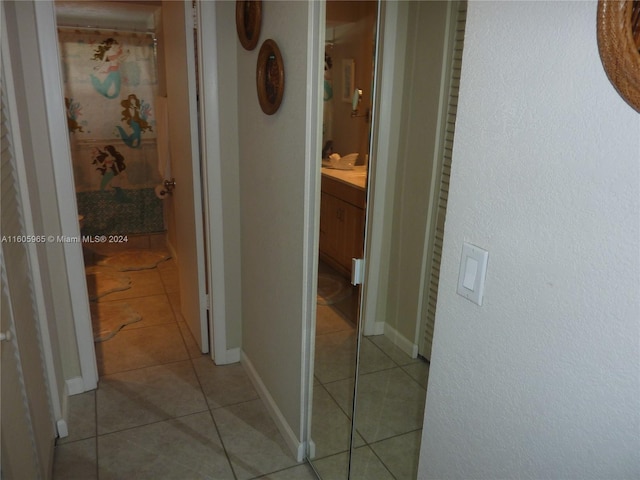 hall featuring light tile patterned floors