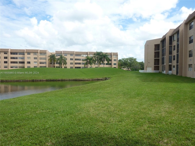 exterior space featuring a water view and a yard