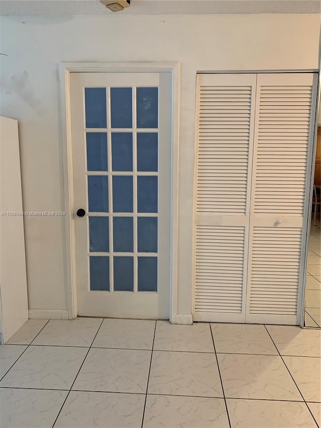 doorway featuring light tile flooring