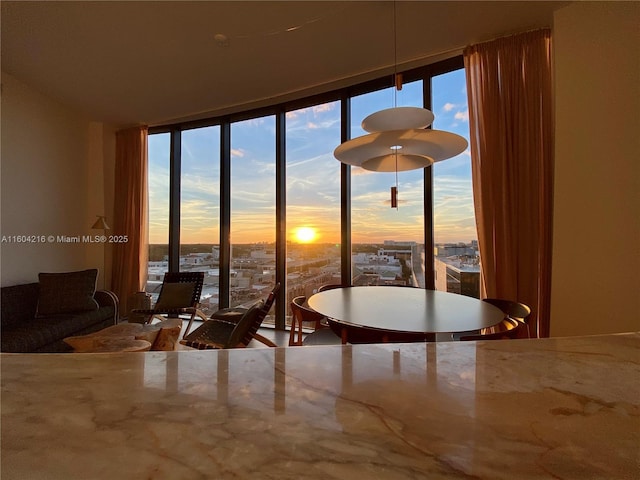 dining space with a view of city and floor to ceiling windows