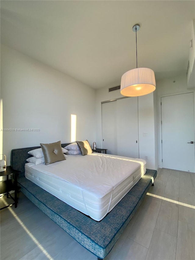 bedroom featuring visible vents and a closet