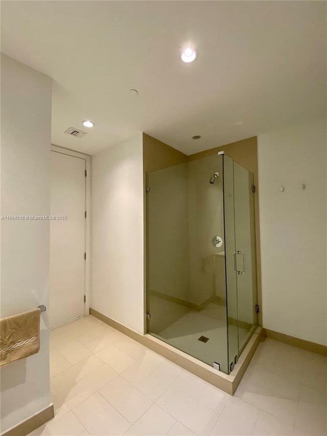 bathroom with a stall shower, visible vents, baseboards, and recessed lighting