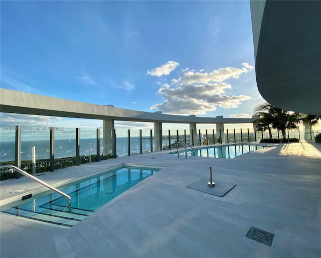 community pool featuring a water view