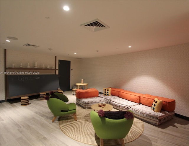 living room with recessed lighting, visible vents, light wood finished floors, and wallpapered walls