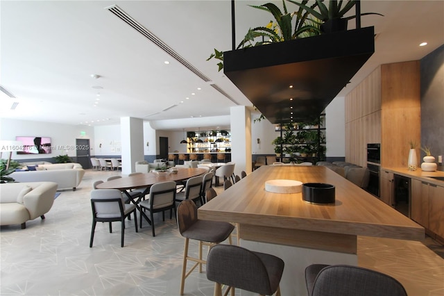 dining area with wine cooler and recessed lighting