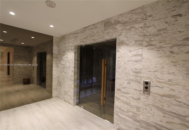 hallway featuring elevator and recessed lighting