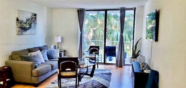 living room with hardwood / wood-style floors and expansive windows