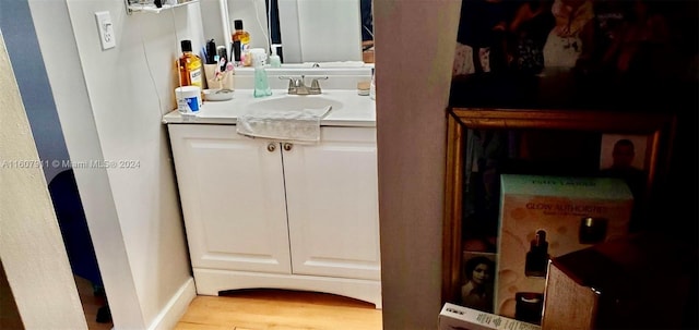 bathroom featuring hardwood / wood-style flooring and vanity