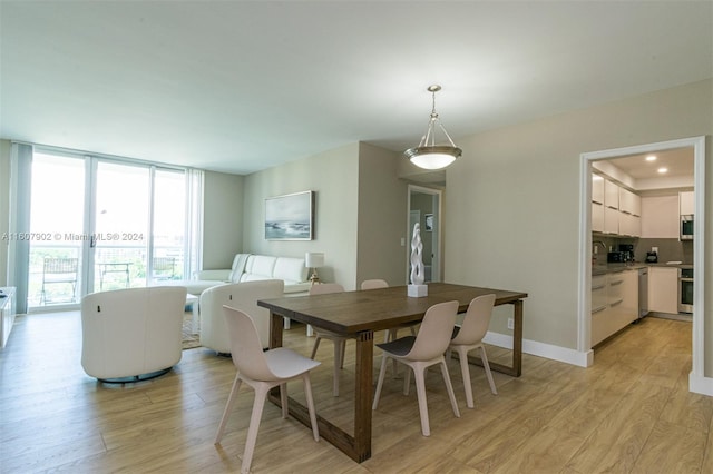 dining room with sink and light hardwood / wood-style floors